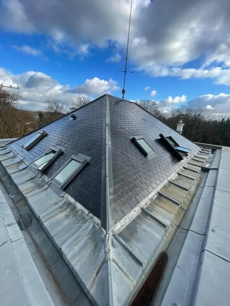 Toiture en ardoise avec fenêtres de toit et zinguerie en zinc